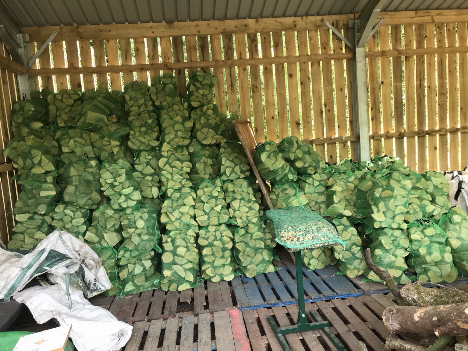 Seasoned firewood stored in vented bags